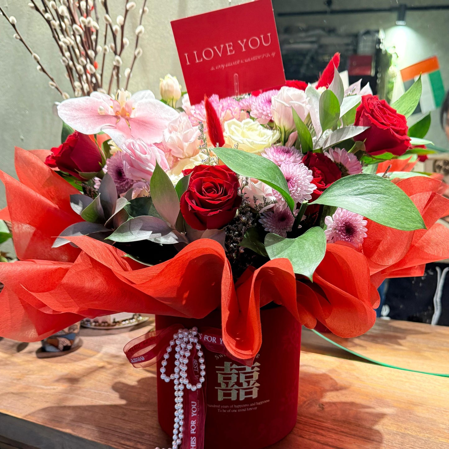 A luxurious fusion of timeless passion and regal charm, the Royal Bloom Box showcases deep red roses paired elegantly with vibrant purple chrysanthemums. Nestled in a chic presentation box, this bouquet radiates bold romance and sophistication — perfect for grand gestures, heartfelt celebrations, or simply to say "you matteA luxurious fusion of timeless passion and regal charm, the Royal Bloom Box showcases deep red roses paired elegantly with vibrant purple chrysanthemums. Nestled in a chic presentation bo